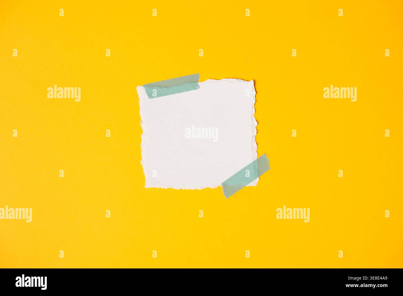 Empty ripped paper label on bright yellow minimal backdrop Stock Photo