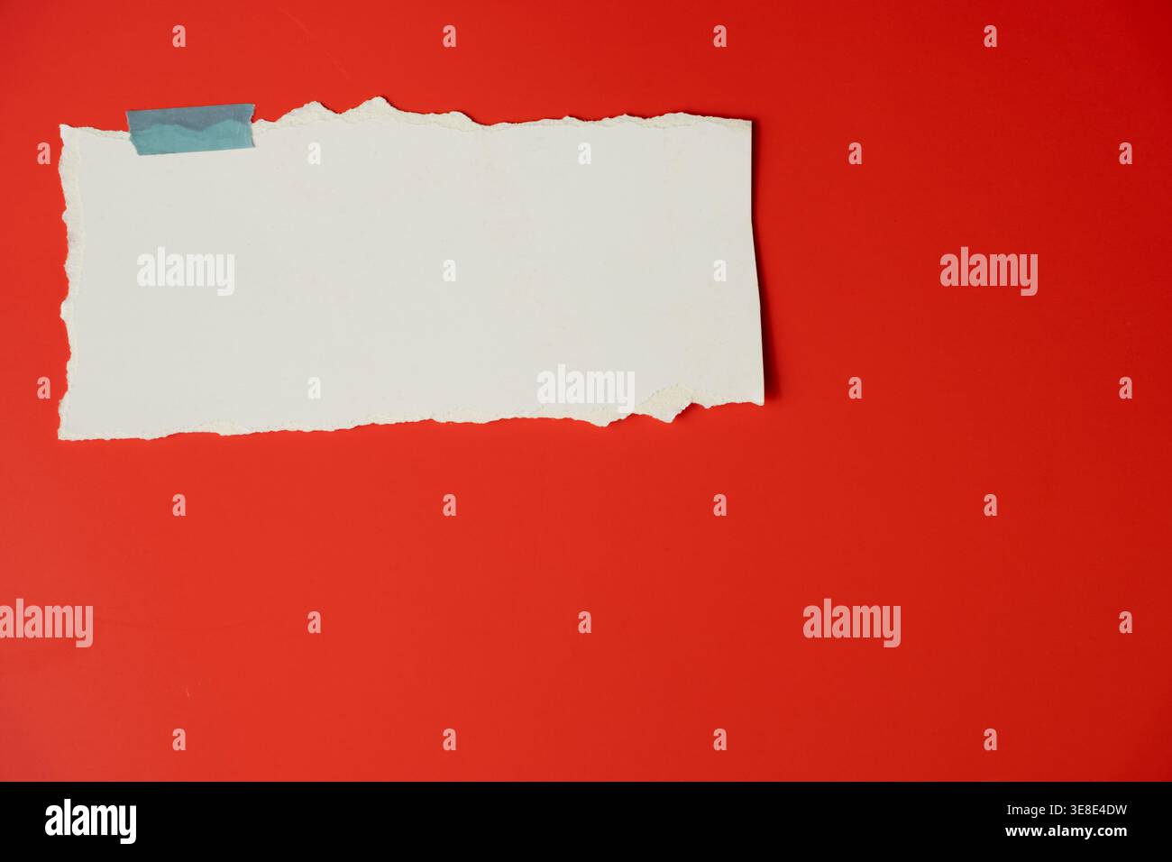 Empty ripped paper label on bright red backdrop minimal design Stock Photo