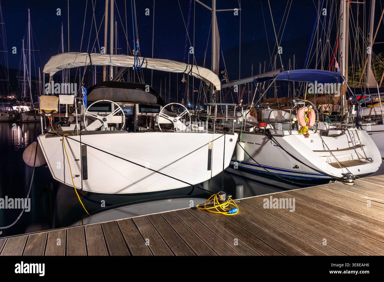 Yachts moored marina calm night illuminated decks reflections water ...