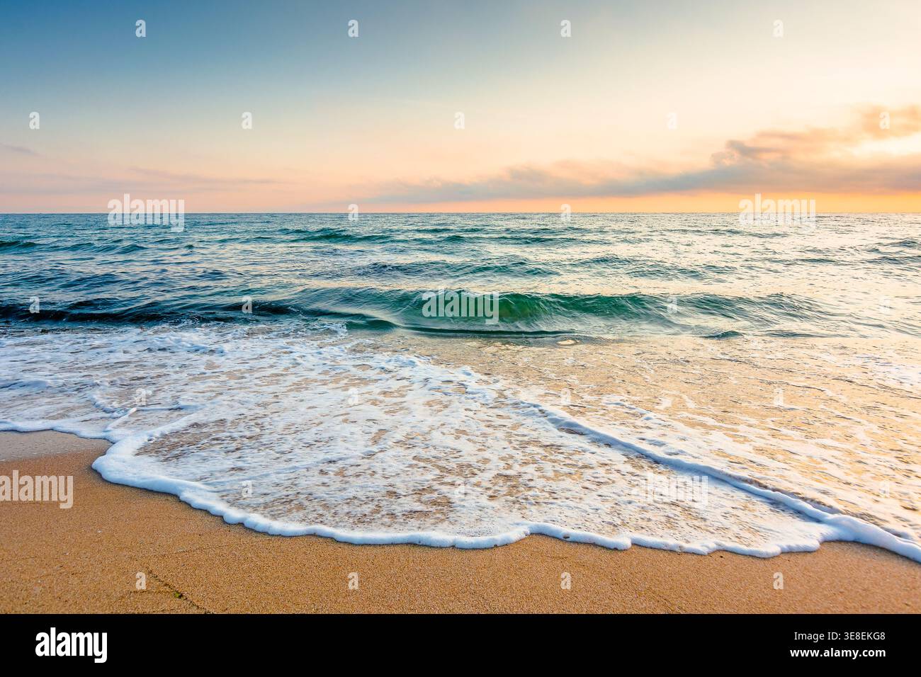 autumn vacation at the sea. beautiful seascape at sunrise. calm waves wash the sandy beach. image with fluffy clouds on the sky above horizon. perfect Stock Photo