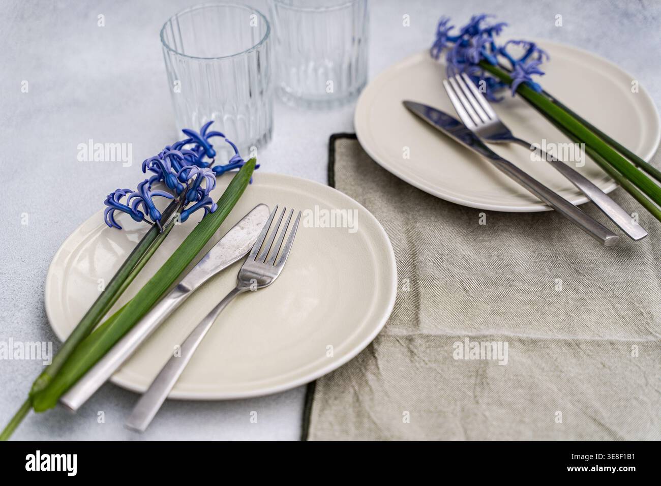 Overhead view of two rustic spring place settings with fresh blue hyacinths on a table Stock Photo