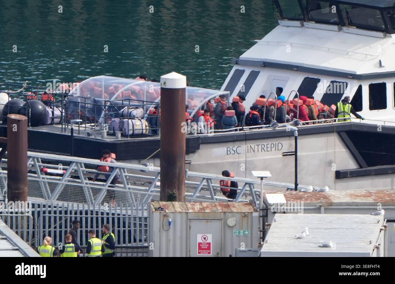 A group of people thought to be migrants are brought in to the Border ...