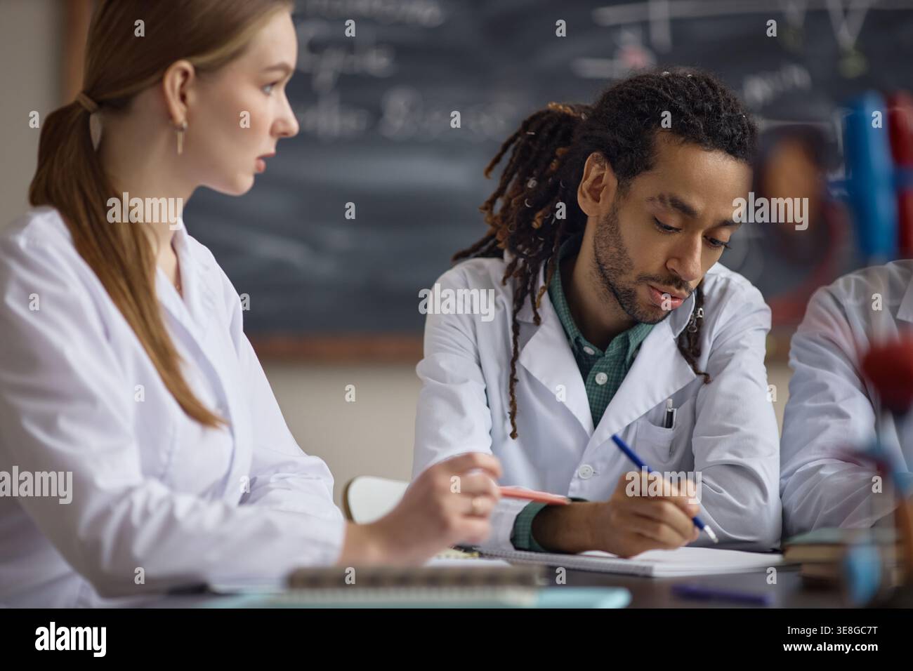 Adult Science Students Collaborating during Classroom Lab Study Stock Photo