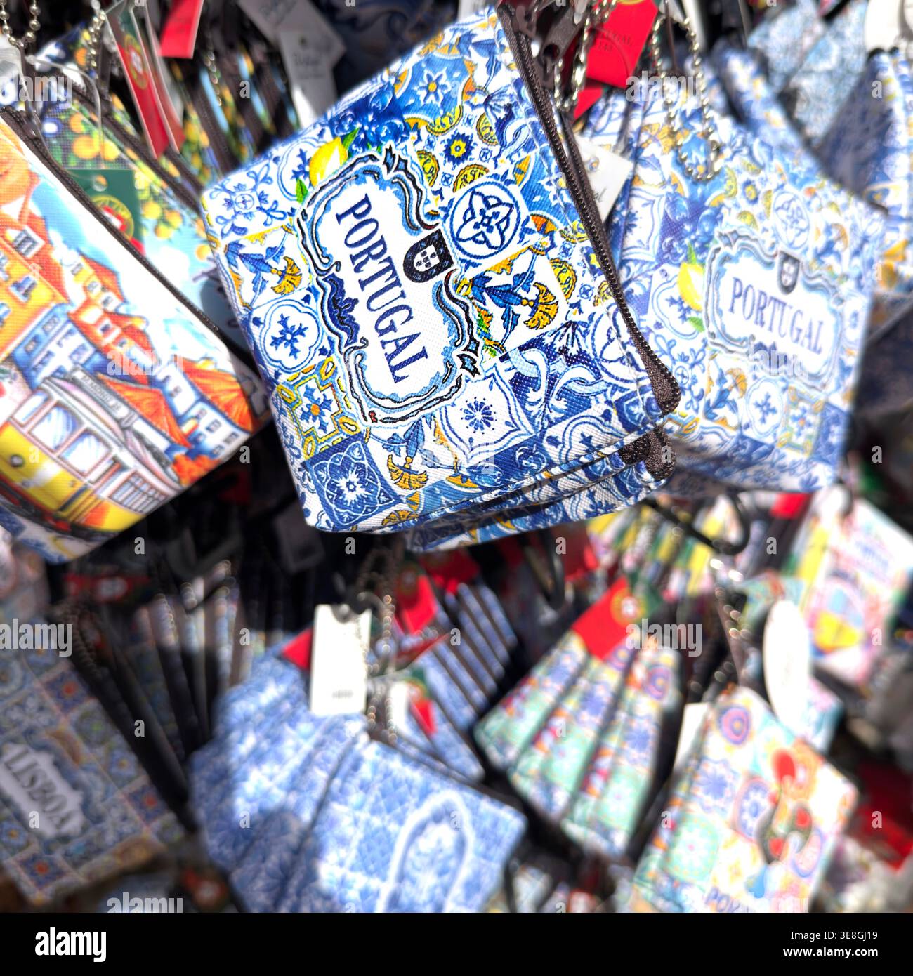 Small souvenir purses with traditional Portuguese azulejo patterns and Lisbon motifs on display at a market stall algarve portugal Stock Photo