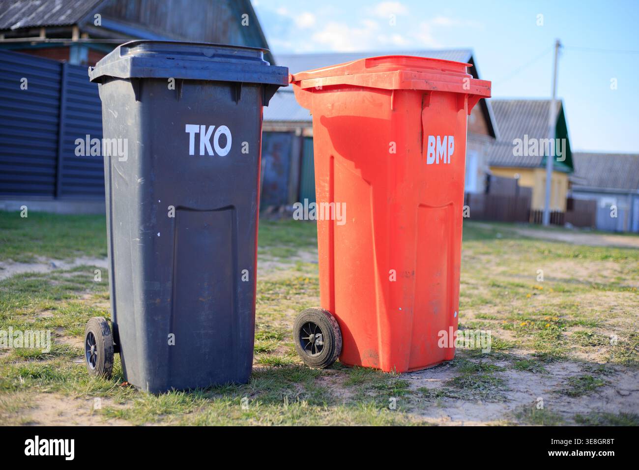 Two plastic wheelie bins for sorted waste collection on a village ...