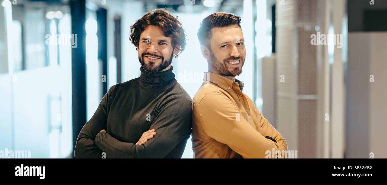 Two Men Stand Back to Back in a Modern Office Setting During Daytime Stock Photo