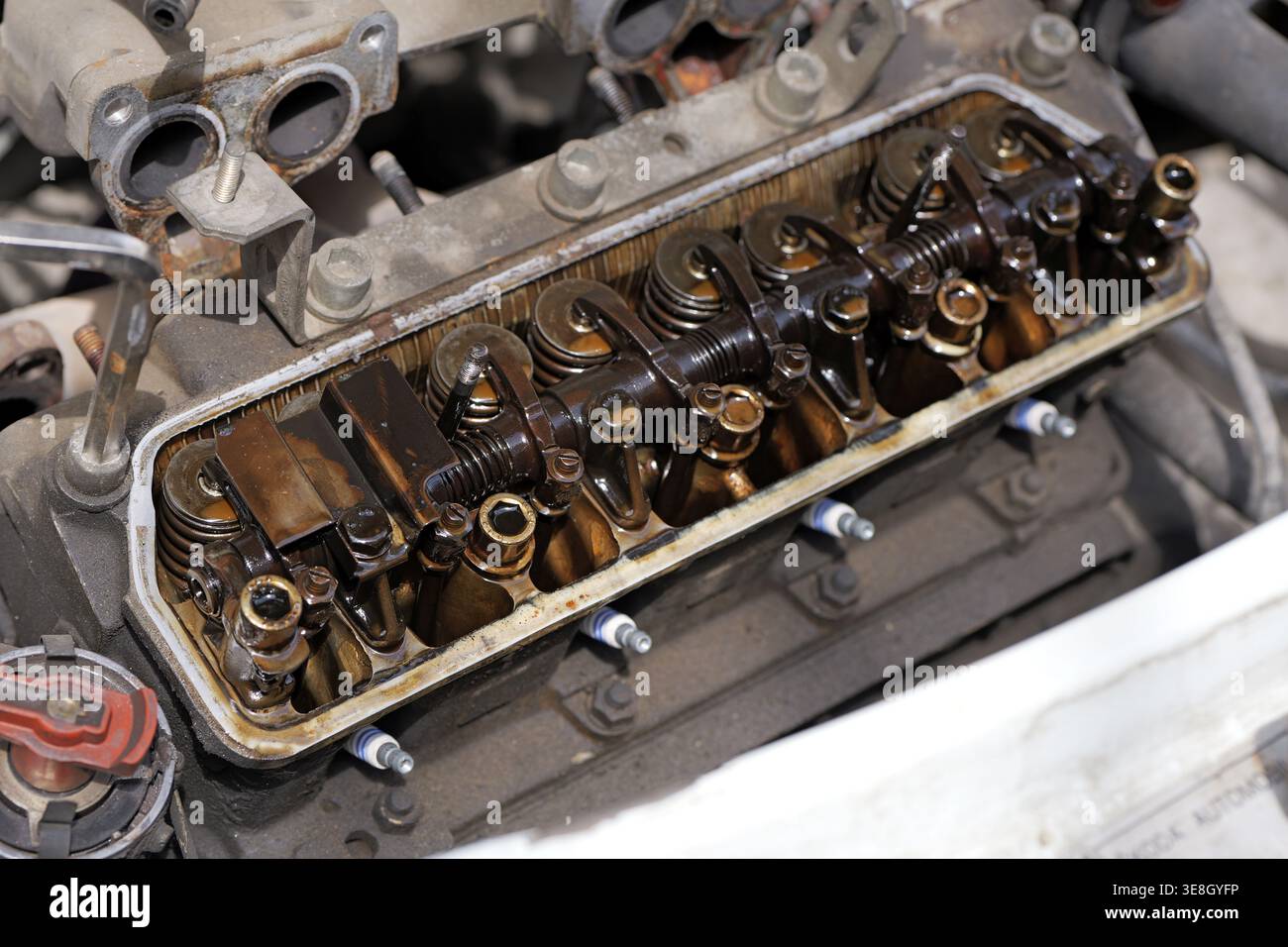 Sludge Up Engine Close-up of an open engine with removed valve cover showing rocker arms ...