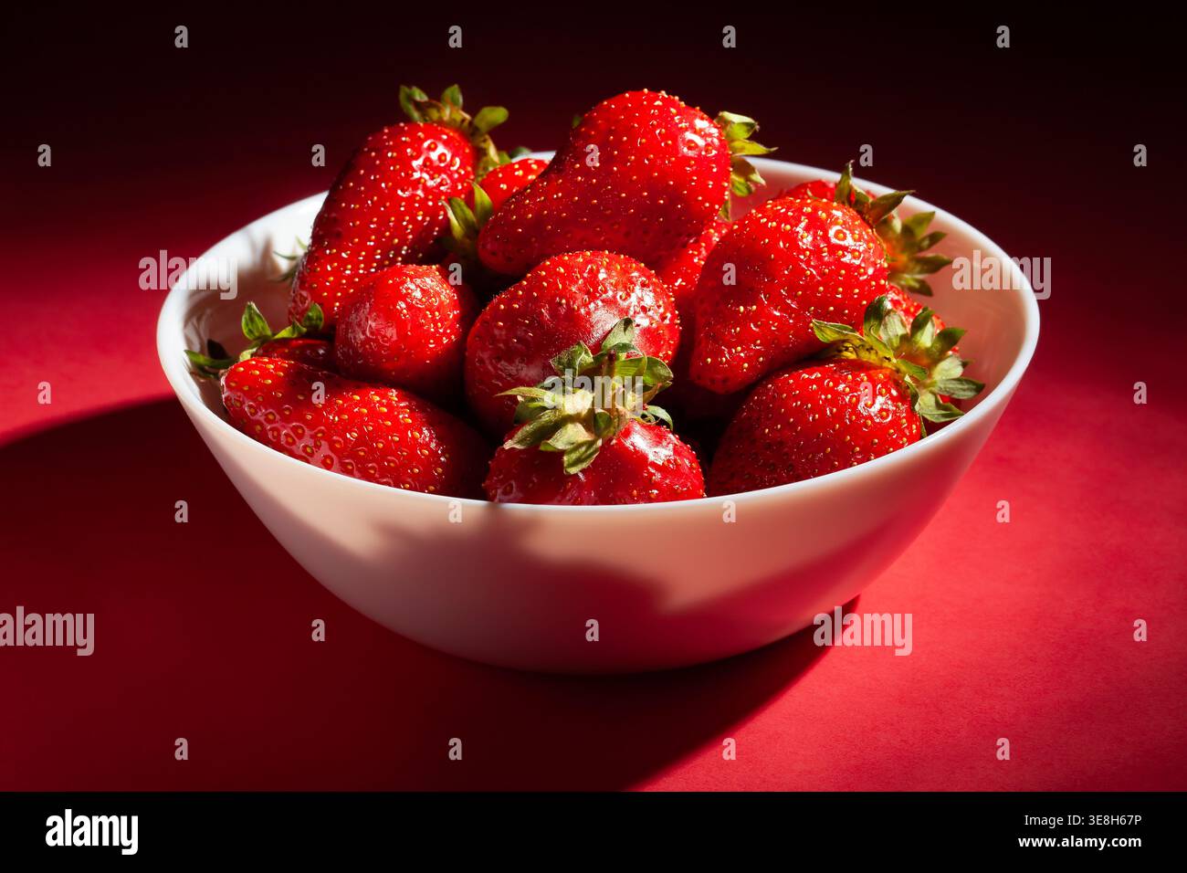 strawberry bowl on red background Stock Photo