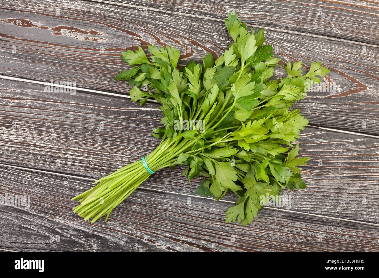 parsley bunch on wood background top view Stock Photo