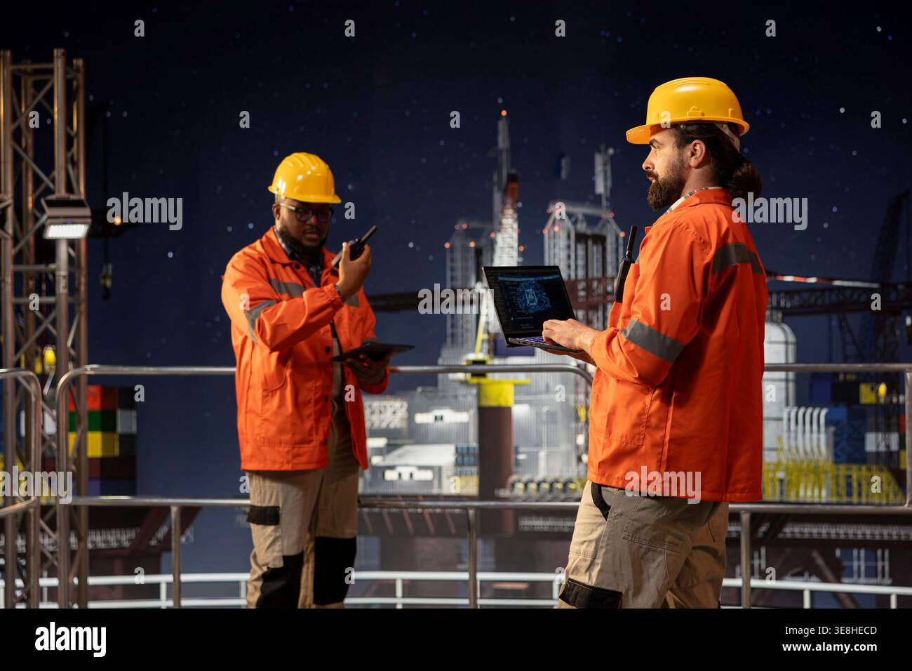 Offshore sea platform technicians using deep learning artificial intelligence to optimize drilling precision. Drilling rig crew monitors equipment performance using AI neural networks tracking system Stock Photo