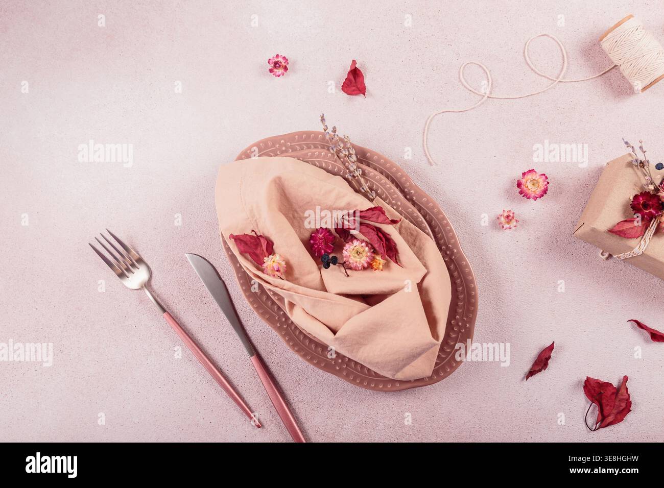 Process of decorating festive autumn table setting with dried flowers. Stock Photo