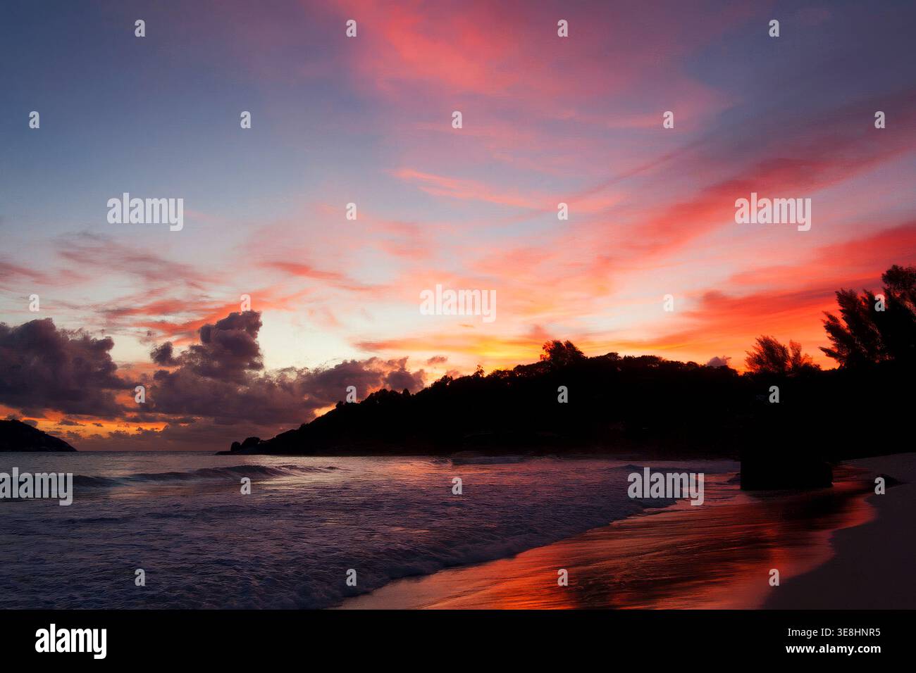 Colorful sunset over tropical coastline on Mahe, Seychelles Stock Photo