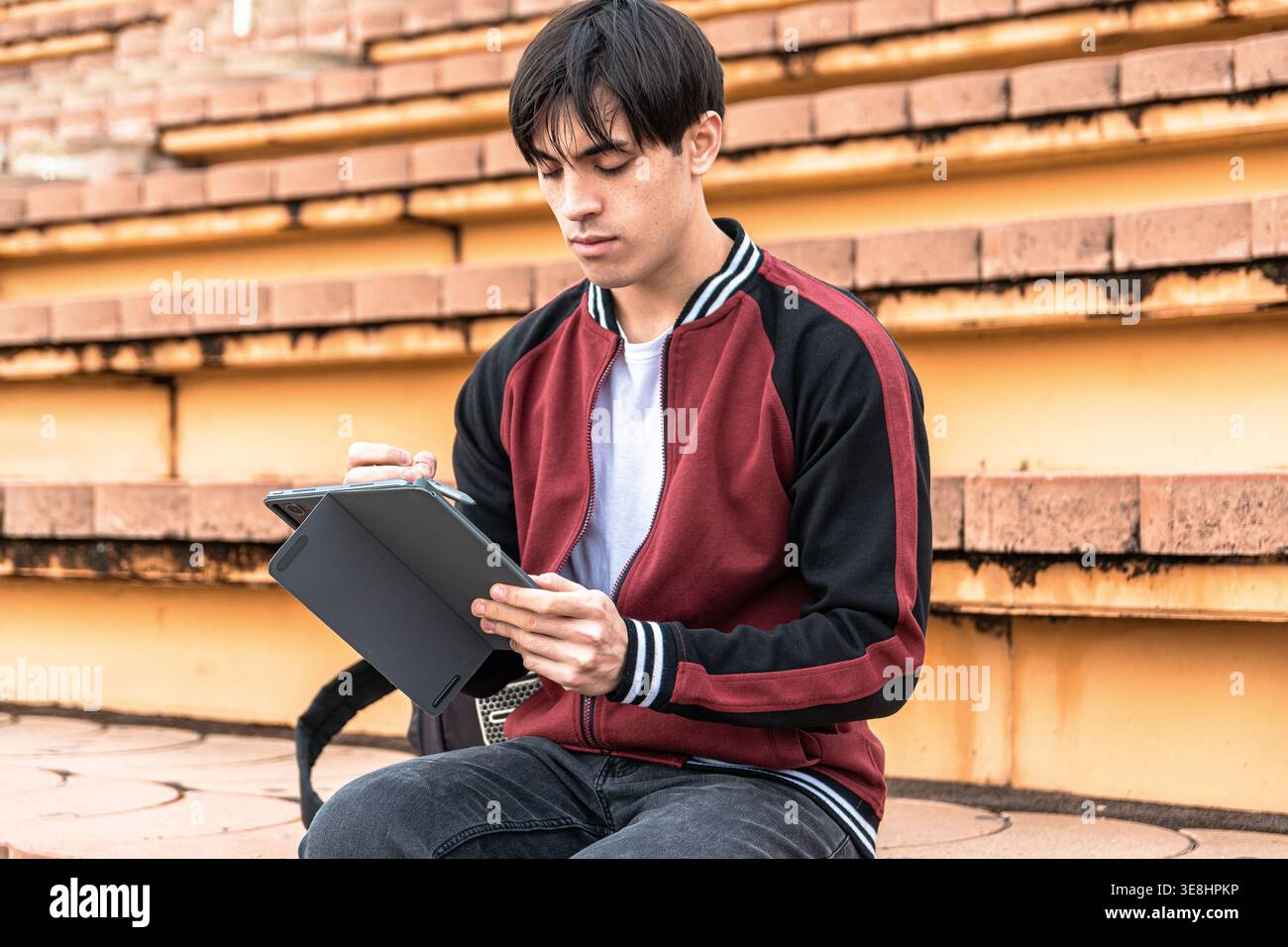 Young man studying with tablet and digital pen Stock Photo