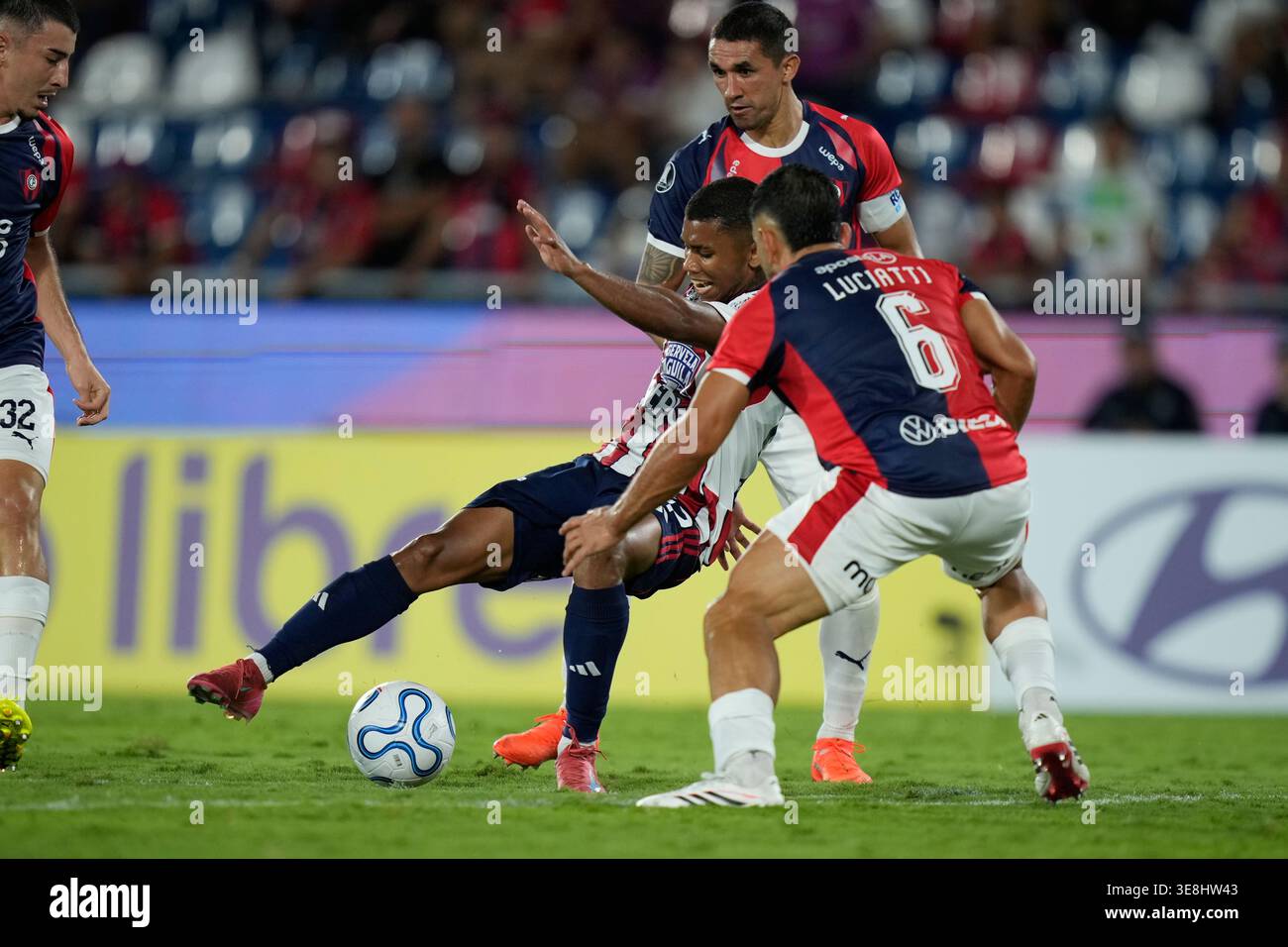 Jesus Rivas of Colombia's Junior, center, fights for the ball with ...