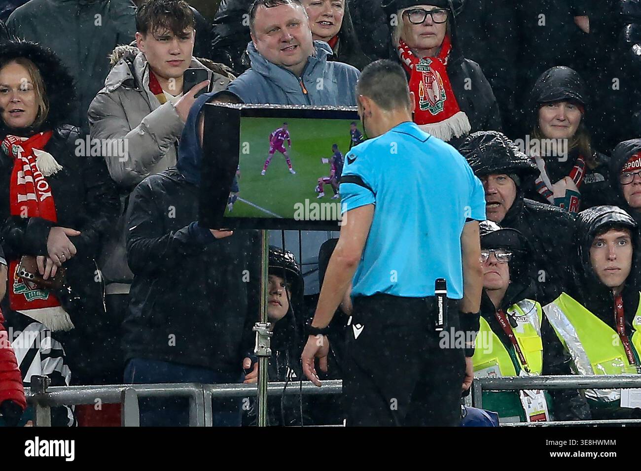 Referee Maurizio Mariani checks the VAR screen to check for a penalty ...
