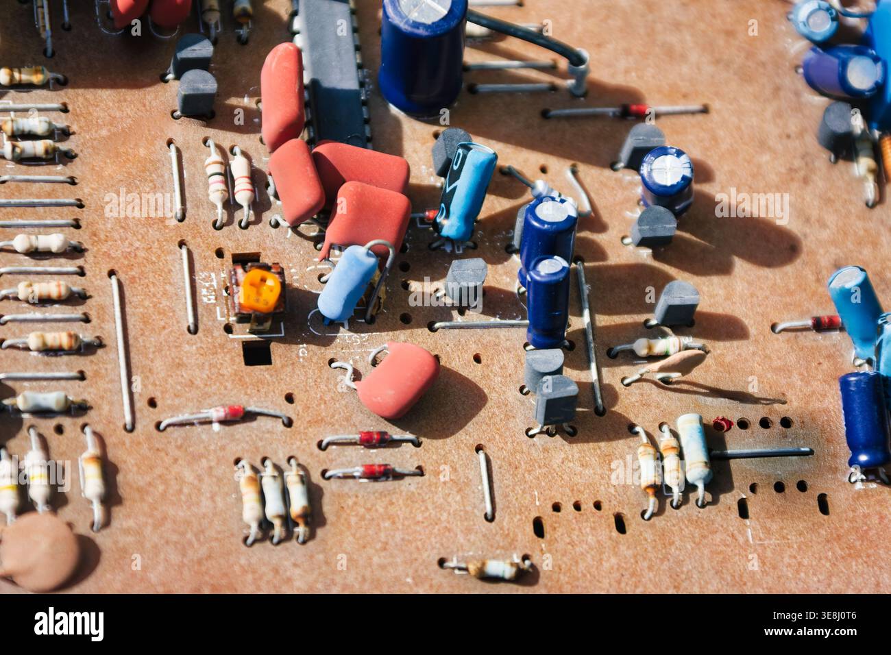 vintage Electronic printed circuit board featuring various resistors capacitors integrated circuits old hardware components technology infrastructure Stock Photo