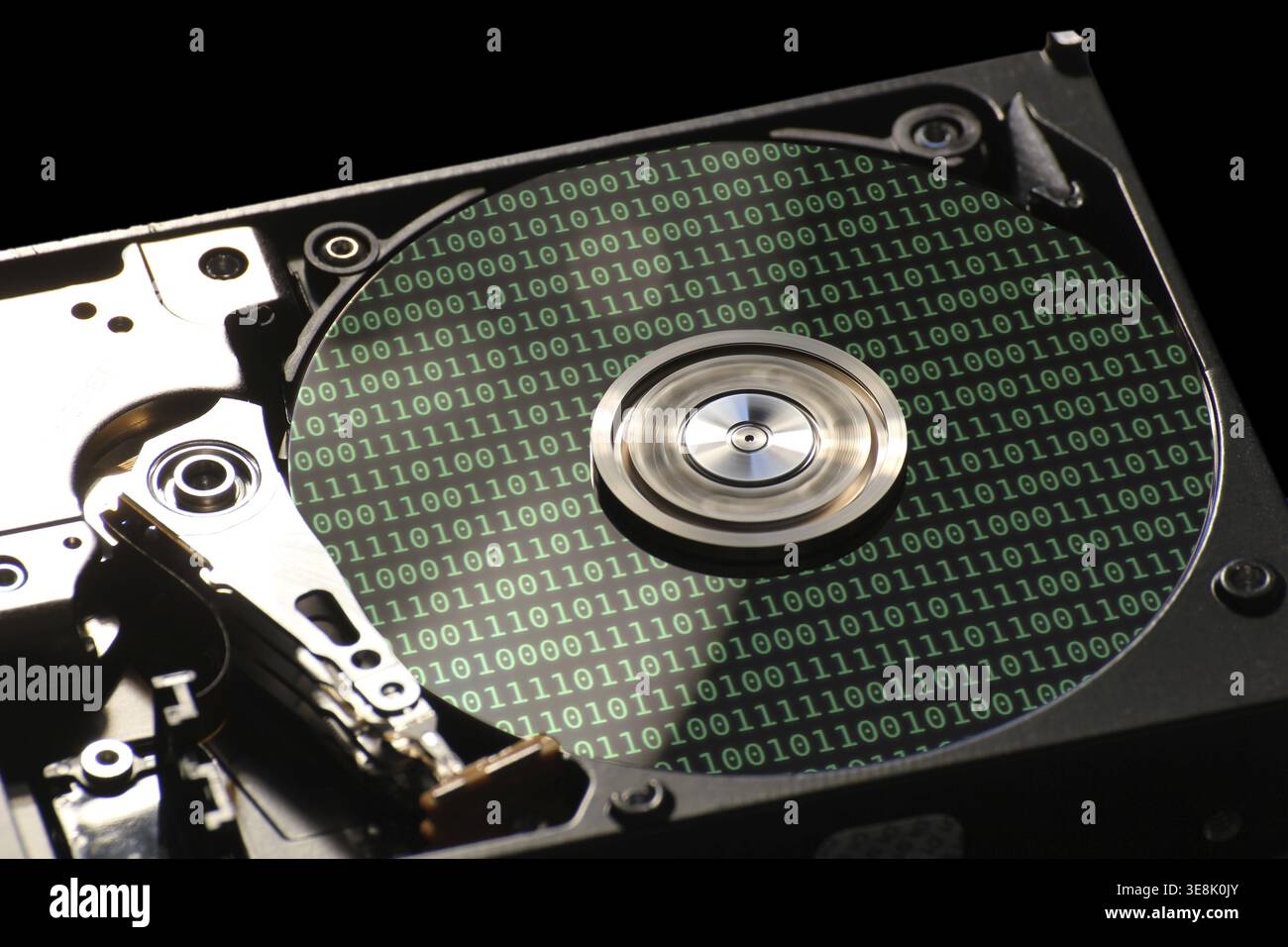 Hard disk on a black background with reflections on ones and zeros (binary code) Stock Photo