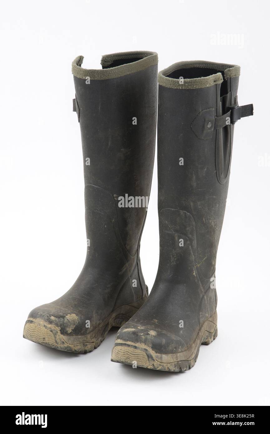 Muddy wellies on a white background Stock Photo