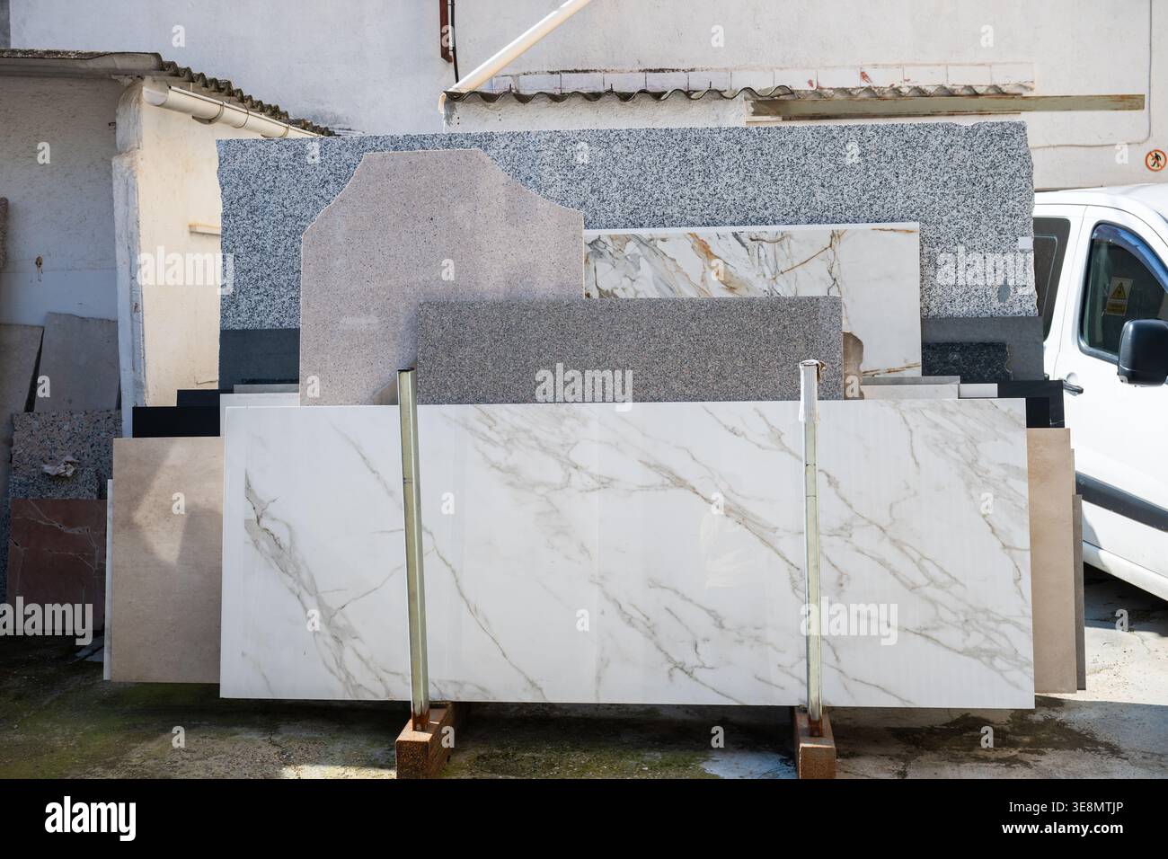 Marble and granite stone slabs display in outdoor construction materials yard Stock Photo