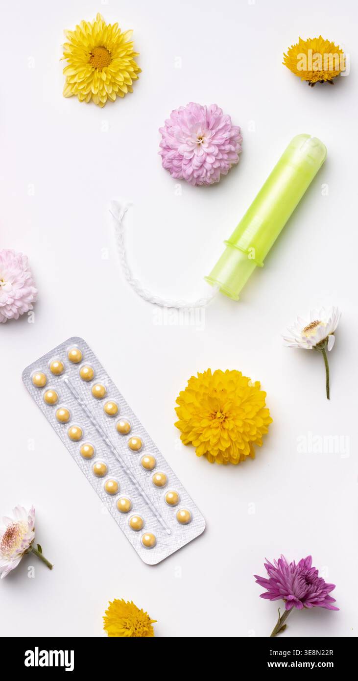 Items related to women's health on a white background with flowers Stock Photo
