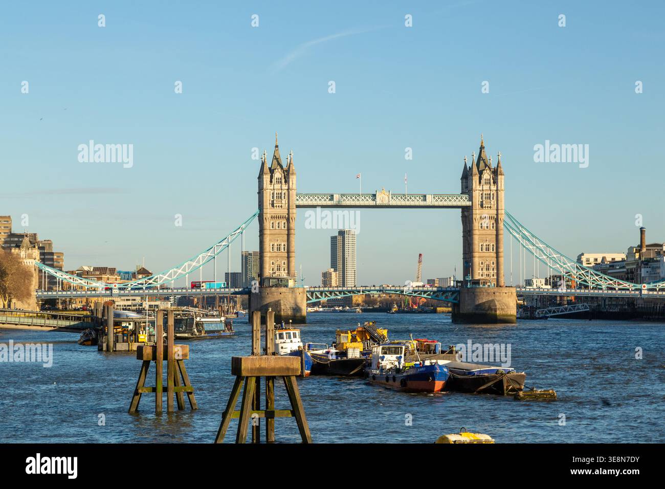 The Tower of London illuminated by late afternoon light seen from the River Thames, London Stock Photo