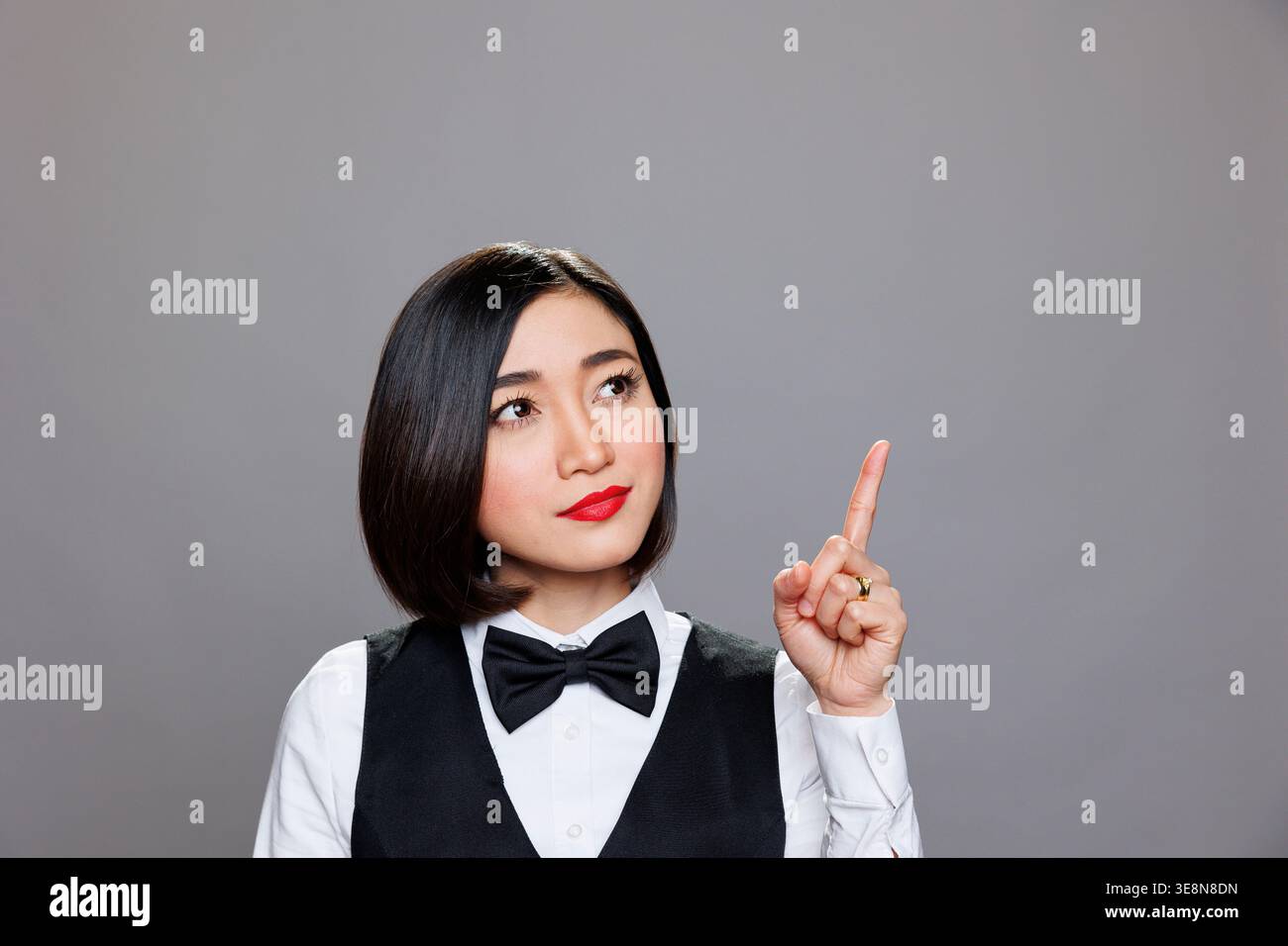 Asian woman pointing upwards hi-res stock photography and images - Alamy