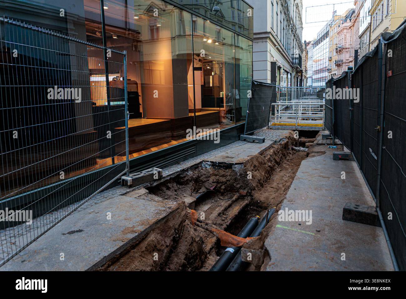 Urban/street Runder An urban street under renovation showing a deep trench with exposed ...