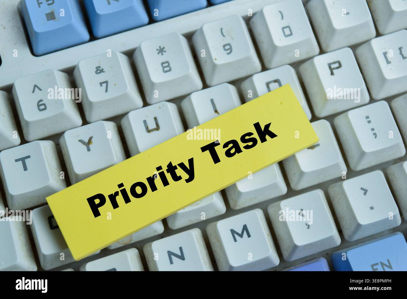 Concept of priority task write on sticky notes isolated on Wooden Table. Stock Photo
