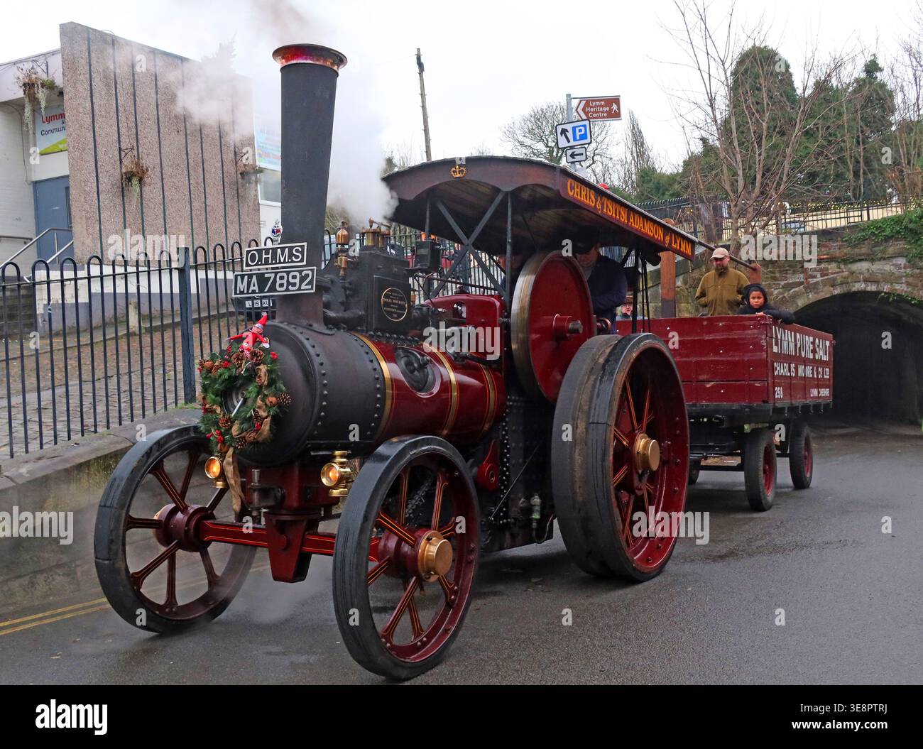 Steam traction engine O.H.M.S. MA7892 towing a trailer through Lymm village during the Dickensian Christmas festival. Stock Photo