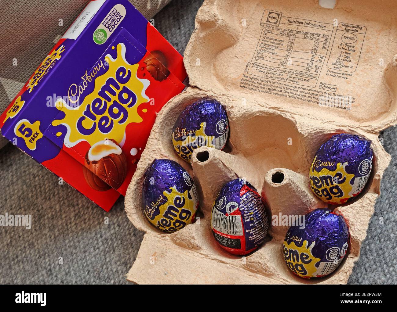 Five Cadbury Creme Eggs in egg box. Stock Photo