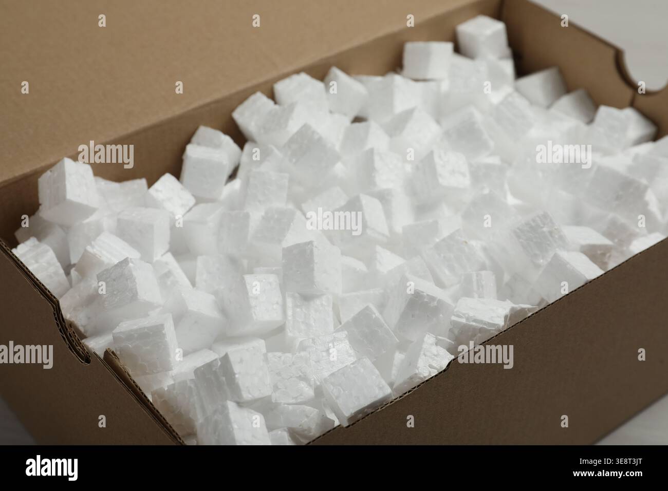 Closeup view of cardboard box with styrofoam cubes Stock Photo