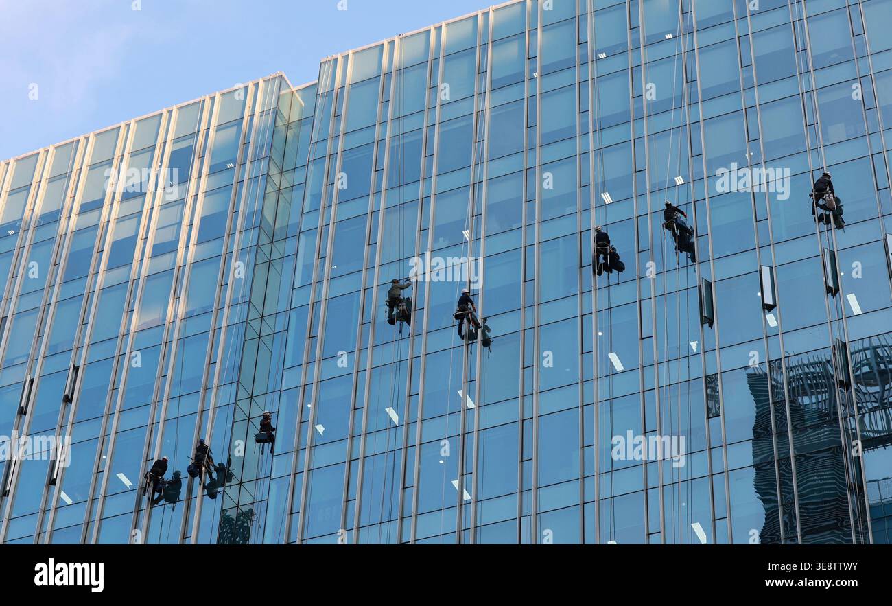 16th Apr, 2026. Spring cleaning Workers, hanging from ropes suspended ...