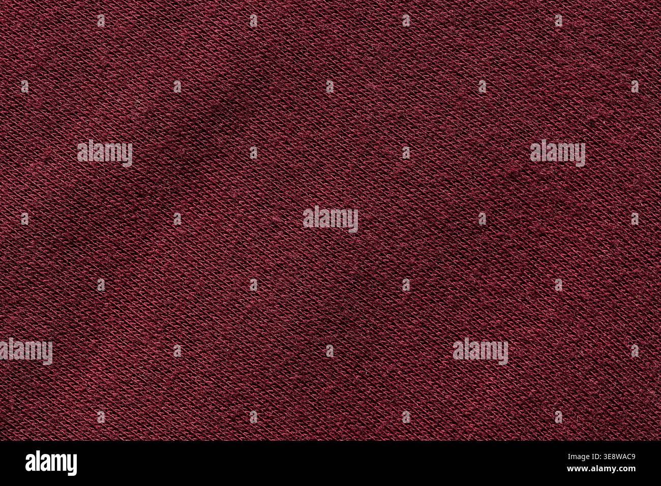 Dark red burgundy knit fabric texture with diagonal weave pattern background close-up Stock Photo