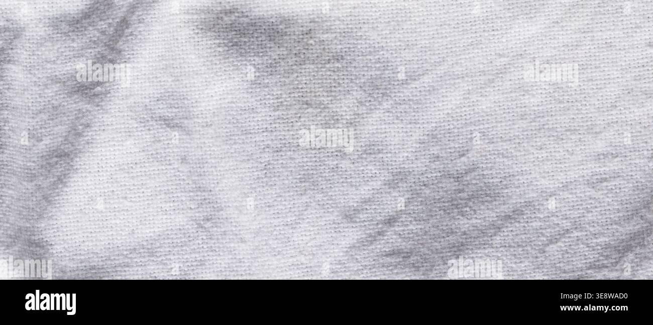 White knitted fabric background with gray tie-dye marbled pattern close-up Stock Photo