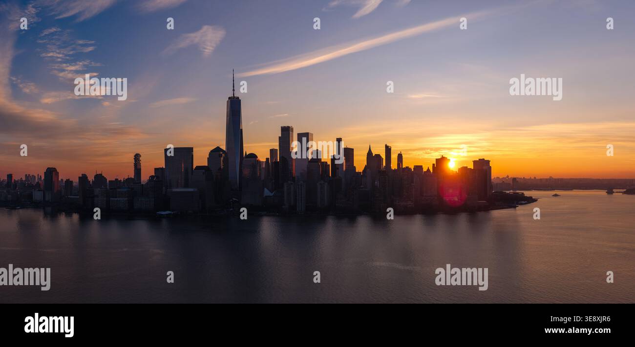 Aerial view of dawn and Lower Manhattan skyline over the Hudson River, New York City. Skyscrapers and urban waterfront at sunrise Stock Photo