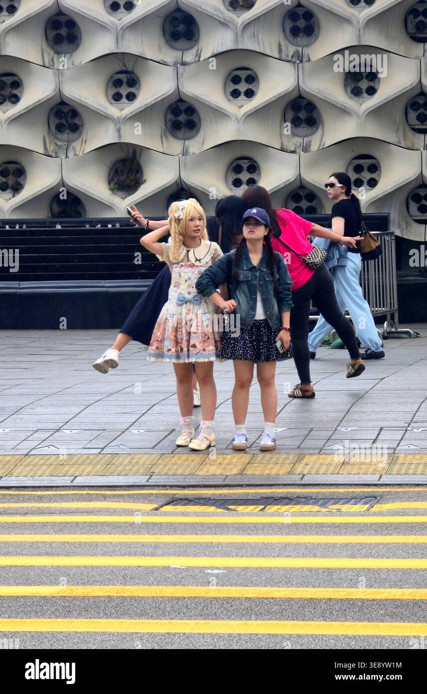 A young Chinese woman dressed in a cosplay outfit in Mongkok, Kowloon, Hong Kong. - Smartphone Captured Stock Image