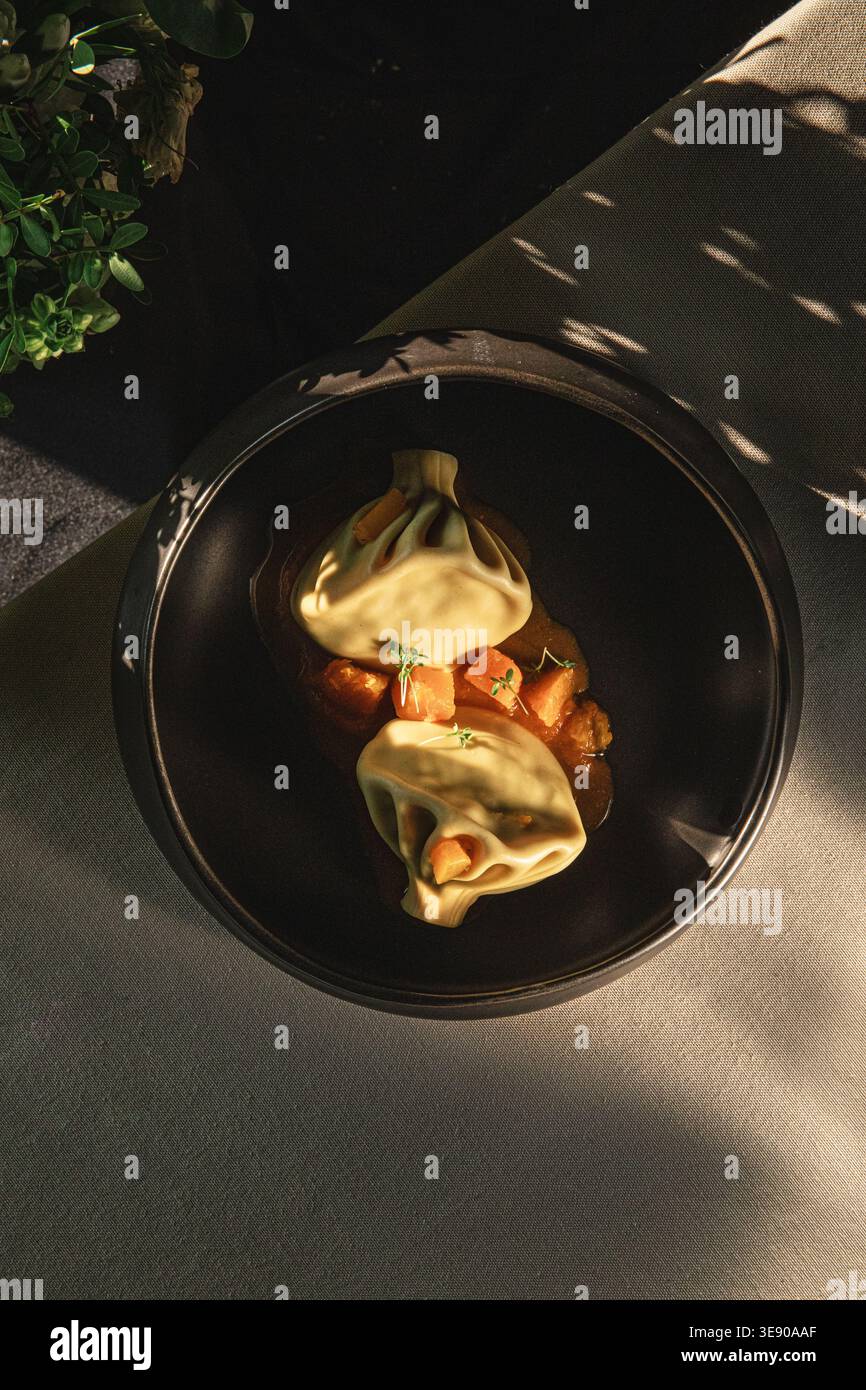Khinkali dumplings with sauce with sunlight Stock Photo