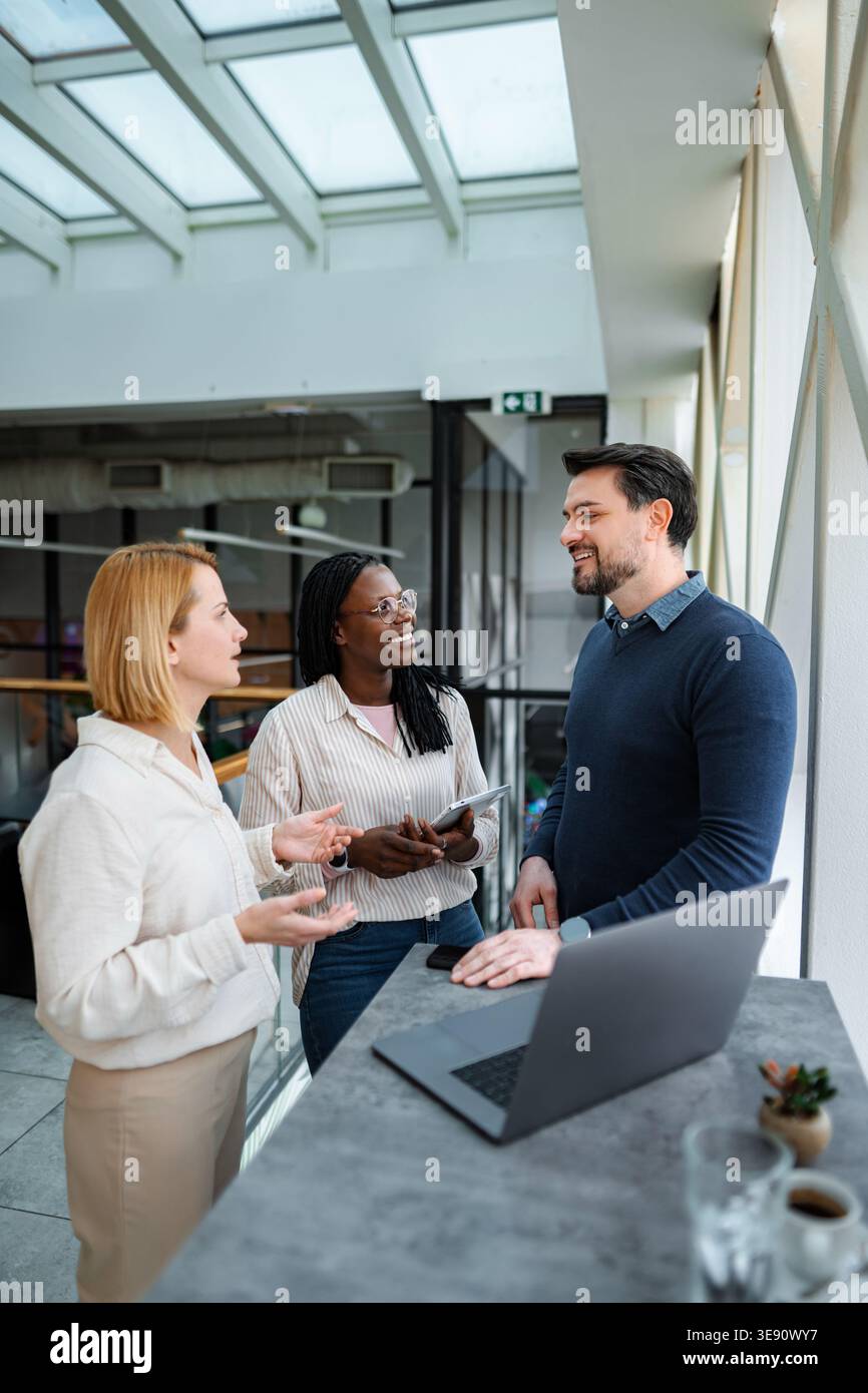 Diverse business professionals collaborating during informal office meeting Stock Photo