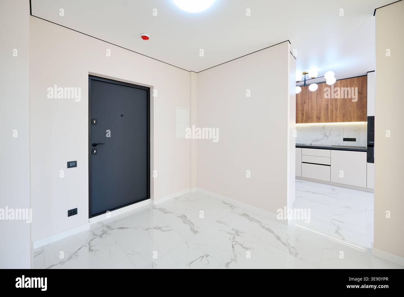 Contemporary residential corridor featuring polished tile flooring ...