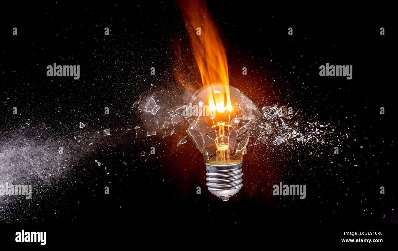 Light real bulb exploding with glass shards Stock Photo