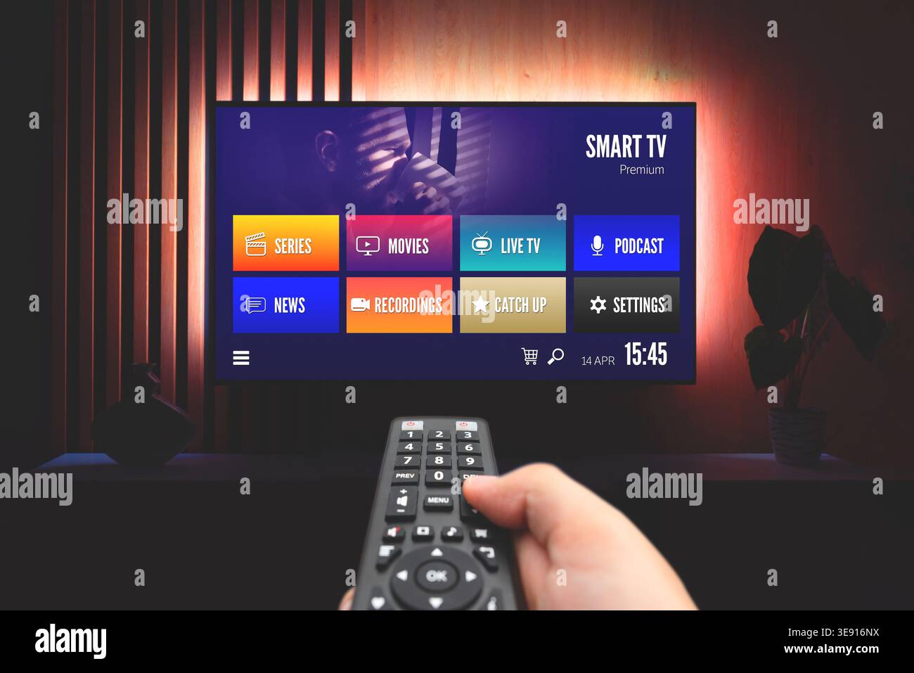 VOD multimedia TV streaming concept with hand holding remote control Stock Photo