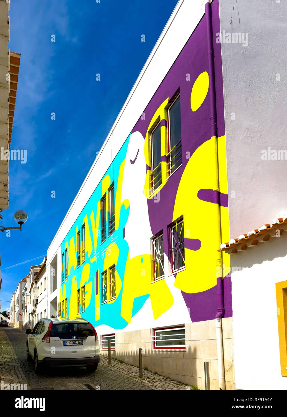 Vibrant and colourful mural painted on the facade of an apartment building with modern windows lagos algarve portugal - Smartphone Captured Stock Image