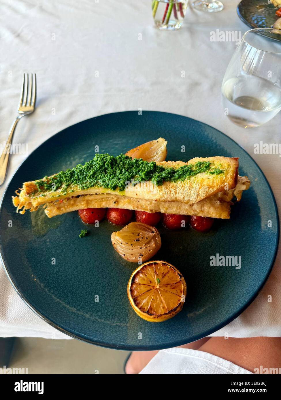 Gourmet Grilled Fish with Salsa Verde and Roasted Vegetables. Stock Photo
