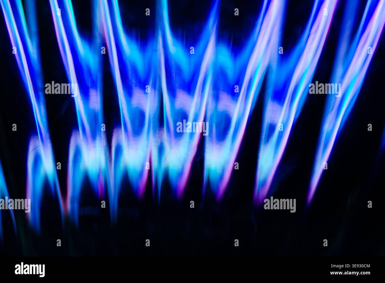 Deep blue and purple vertical flame like light structures Stock Photo