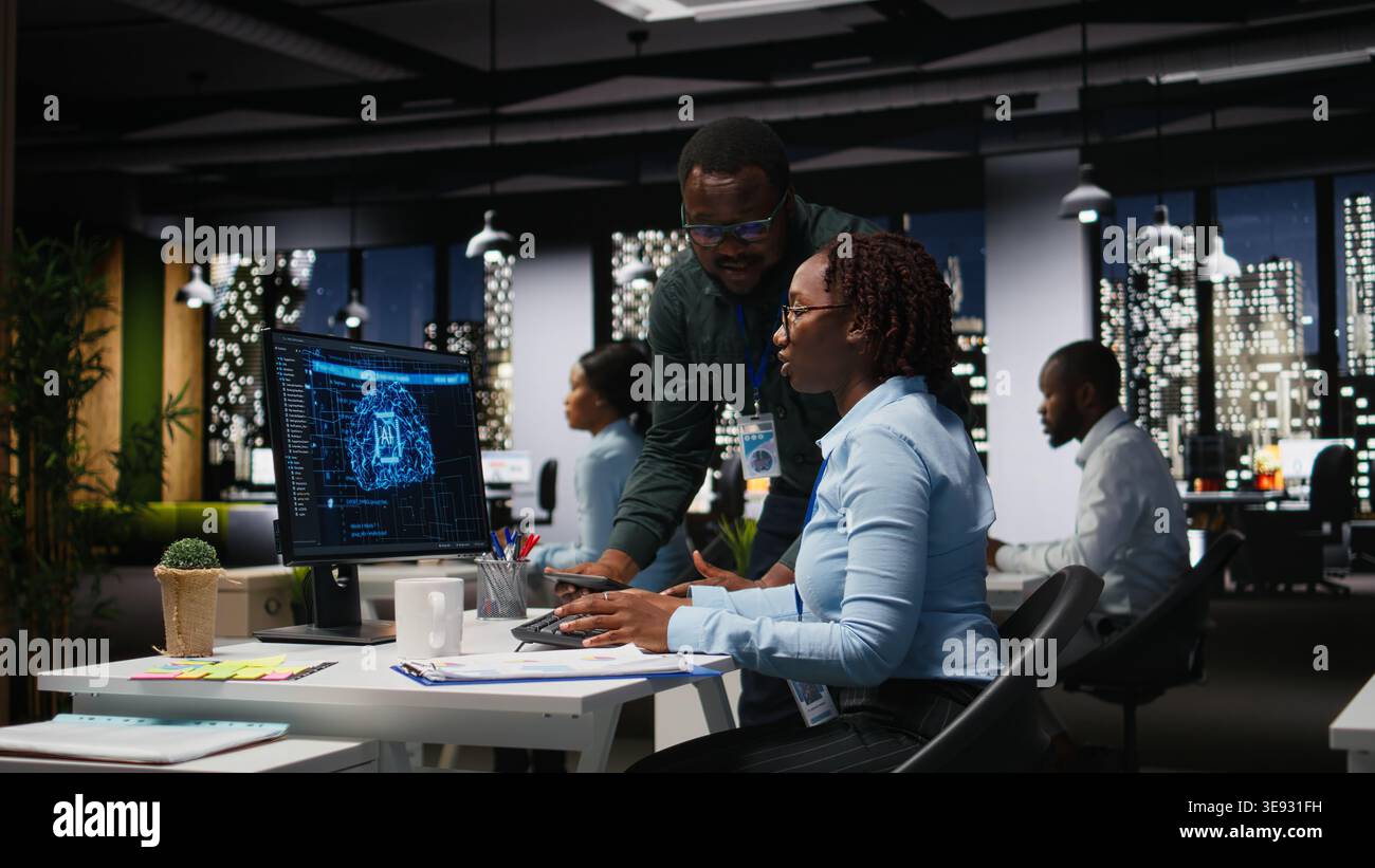 Black team of colleagues use artificial intelligence and predictive analytics, checking smart work solutions and cloud computing for adaptive strategies. AI engineering algorithms. Stock Photo