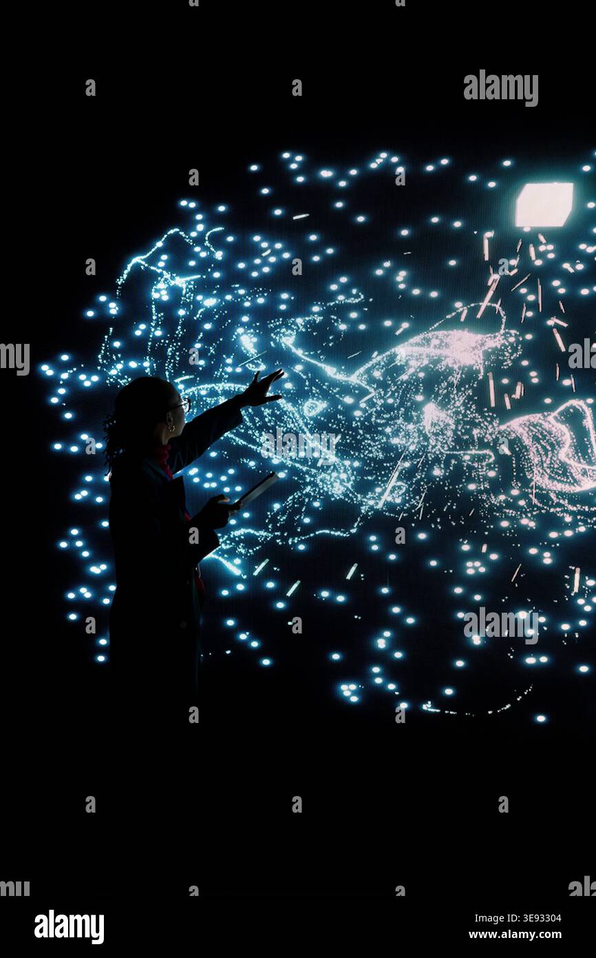 Female scientist fine tuning AI model node clusters with laptop to upgrade processing speed. Software developer uses augmented reality tech to optimize deep learning neural network neurons map Stock Photo