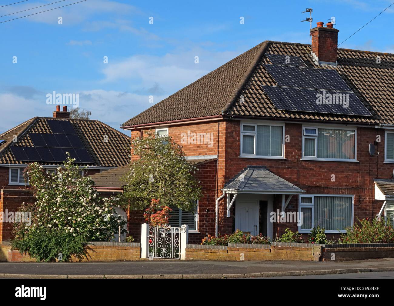 Solar photovoltaic panels fitted to a suburban semi-detached house in Warrington, Cheshire, England. Stock Photo