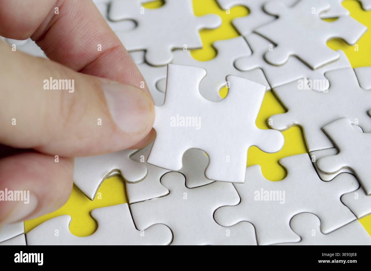 Close up of hand place missing jigsaw puzzle representing problem solving skill Stock Photo