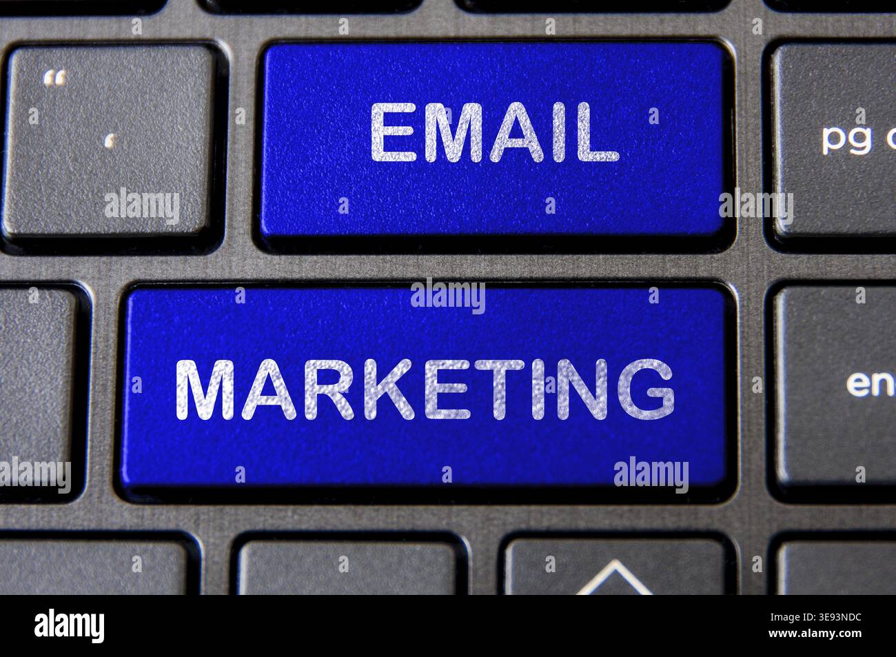 Online business concept - Laptop keyboard with blue Email Marketing button Stock Photo