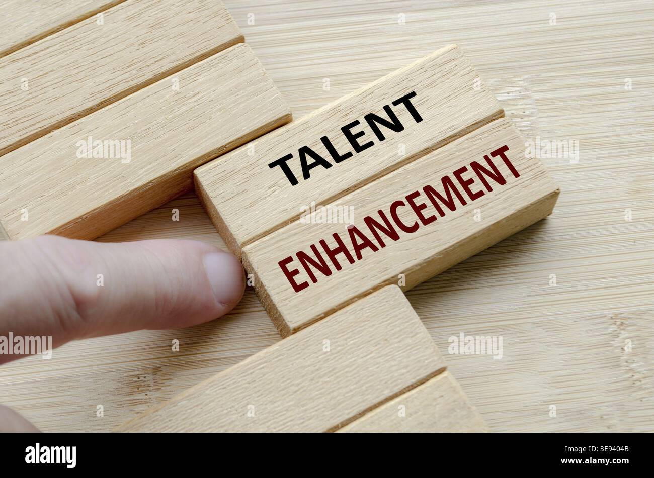 TALENT ENHANCEMENT text on wooden blocks, Focused talent enhancement programs to nurture abilities and maximize organizational potential and results Stock Photo